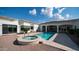 Backyard featuring a pool and jacuzzi with a tiled deck, and white-exterior home with views to interior rooms via arched doorways at 3126 E Fruitvale Ct, Gilbert, AZ 85297