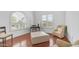 Comfortable sitting area with an ottoman, chairs, and natural lighting through windows at 3126 E Fruitvale Ct, Gilbert, AZ 85297