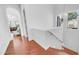 Staircase landing with natural light, hardwood floors, a decorative chandelier, and access to the main floor at 3126 E Fruitvale Ct, Gilbert, AZ 85297