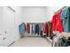 Walk-in closet with organized hanging racks and shelving, plus hardwood floors at 3126 E Fruitvale Ct, Gilbert, AZ 85297