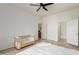 Bright bedroom with wood floors, fan, and ensuite bathroom at 3131 E Legacy Dr # 2113, Phoenix, AZ 85042