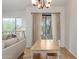 Dining area shows a wooden table with views of the living room and outside with natural light at 3131 E Legacy Dr # 2113, Phoenix, AZ 85042