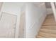 Bright hallway features a staircase with white railing and multiple entry doors for easy access at 3131 E Legacy Dr # 2113, Phoenix, AZ 85042