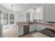 Bright kitchen with light wood floors, stainless steel dishwasher, and breakfast bar seating area at 3131 E Legacy Dr # 2113, Phoenix, AZ 85042