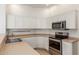 Bright kitchen featuring stainless steel appliances, white cabinets and light countertops at 3131 E Legacy Dr # 2113, Phoenix, AZ 85042
