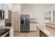 Bright kitchen with stainless steel fridge, wood floors and white cabinetry at 3131 E Legacy Dr # 2113, Phoenix, AZ 85042