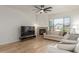 This living room boasts a corner fireplace, large window, modern ceiling fan, and neutral decor at 3131 E Legacy Dr # 2113, Phoenix, AZ 85042
