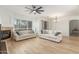Bright living room features wood-look floors, ample seating, a fireplace, and modern ceiling fan at 3131 E Legacy Dr # 2113, Phoenix, AZ 85042