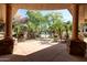 Beautiful pool view from an arched entryway lined with mature trees and landscaping at 3131 E Legacy Dr # 2113, Phoenix, AZ 85042