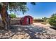 Spacious backyard features a storage shed and a patio area with a fire pit at 3251 W Mercer Ln, Phoenix, AZ 85029