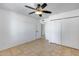 Bedroom with tile floors, white walls, a ceiling fan, and a large closet with doors at 3251 W Mercer Ln, Phoenix, AZ 85029