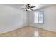 Bedroom with tile floors, white walls, a ceiling fan, and a window with natural light at 3251 W Mercer Ln, Phoenix, AZ 85029