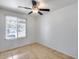 Bedroom with tile floors, white walls, a ceiling fan, and a large window with natural light at 3251 W Mercer Ln, Phoenix, AZ 85029
