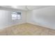 Bedroom with tile floors, white walls, a ceiling fan, and a window overlooking the backyard at 3251 W Mercer Ln, Phoenix, AZ 85029