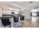 Stylish kitchen features a breakfast bar with granite countertops and pendant lighting at 3251 W Mercer Ln, Phoenix, AZ 85029