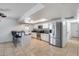 Modern kitchen with stainless steel appliances, granite counters, and a breakfast bar at 3251 W Mercer Ln, Phoenix, AZ 85029