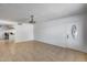 Open living room features neutral tile flooring and a traditional ceiling fan at 3251 W Mercer Ln, Phoenix, AZ 85029