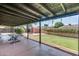 Spacious covered patio offering backyard views, a well-manicured lawn, and ample space for outdoor furniture at 3251 W Mercer Ln, Phoenix, AZ 85029