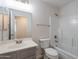 Bathroom with a single sink vanity and shower over tub with white tile at 3313 W Wayland Dr, Phoenix, AZ 85041