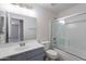 Bathroom featuring a single sink vanity and a shower over tub with glass doors at 3313 W Wayland Dr, Phoenix, AZ 85041