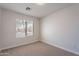 Bright bedroom with a window offers natural light and neutral carpet flooring at 3313 W Wayland Dr, Phoenix, AZ 85041