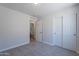 Bedroom with neutral carpet flooring, walk-in closet and en-suite bathroom at 3313 W Wayland Dr, Phoenix, AZ 85041