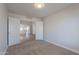 Bedroom featuring double doors open to another room and neutral carpet flooring at 3313 W Wayland Dr, Phoenix, AZ 85041