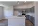 Contemporary kitchen with stainless appliances, center island, and ample cabinet space at 3313 W Wayland Dr, Phoenix, AZ 85041