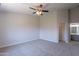Spacious main bedroom features a ceiling fan, neutral carpet, and en-suite bathroom at 3313 W Wayland Dr, Phoenix, AZ 85041
