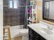 Bathroom with updated vanity, tiled shower and a window letting in natural light at 3627 W Hayward Ave, Phoenix, AZ 85051