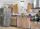 Galley kitchen with stainless steel refrigerator, stainless steel dishwasher and tile floor at 3627 W Hayward Ave, Phoenix, AZ 85051