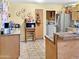 Galley kitchen with appliances, cabinets, laminate countertops and tile floor at 3627 W Hayward Ave, Phoenix, AZ 85051