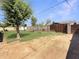Large backyard featuring mature trees, green grass, concrete block fence and partial patio at 4122 W Las Palmaritas Dr, Phoenix, AZ 85051