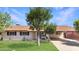 Charming home with lush front yard, mature trees and covered parking at 4122 W Las Palmaritas Dr, Phoenix, AZ 85051