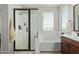 A bathroom with a walk-in shower and separate soaking tub under a bright window at 4173 E Jones St, Gilbert, AZ 85295