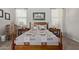 Bedroom with wooden furniture, including a queen bed with soft pillows, and bright windows at 4173 E Jones St, Gilbert, AZ 85295