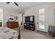 Bedroom featuring a TV, dresser, and a door to an outdoor balcony for relaxation at 4173 E Jones St, Gilbert, AZ 85295