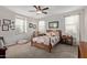 Bright bedroom with a wooden-framed bed and decorative pillows and window with natural light at 4173 E Jones St, Gilbert, AZ 85295