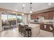 Bright kitchen featuring a center island, pendant lighting, and sliding glass doors to the backyard at 4173 E Jones St, Gilbert, AZ 85295