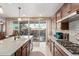 Well-equipped kitchen with granite countertops, stainless steel appliances, and a view to the outdoor patio at 4173 E Jones St, Gilbert, AZ 85295