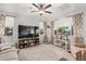 Bright living room with a large television, neutral color scheme, and ample natural light from multiple windows at 4173 E Jones St, Gilbert, AZ 85295