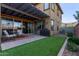 Landscaped backyard featuring a covered patio, artificial turf, and outdoor seating area at 4173 E Jones St, Gilbert, AZ 85295