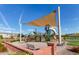 Community playground featuring colorful play structures, a sun shade, and seating area at 4173 E Jones St, Gilbert, AZ 85295