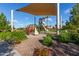 Community playground with a large sunshade, climbing structures, and surrounded by landscaping at 4173 E Jones St, Gilbert, AZ 85295