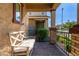 Cozy porch with brick pillars, iron railing, and a cushioned bench for relaxing outdoors at 4173 E Jones St, Gilbert, AZ 85295