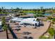 The shot reveals a home near a pond, set amidst a landscape of palm trees and cacti at 420 S 80Th Pl, Mesa, AZ 85208