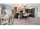 Open concept living area with a bar, barstools, and a view of the dining area and a white pantry door at 420 S 80Th Pl, Mesa, AZ 85208
