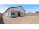 Backyard of house with covered patio, and privacy wall at 42510 W Peters Dr, Maricopa, AZ 85138