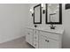Elegant bathroom featuring dual sinks, modern fixtures, and tile floors at 42510 W Peters Dr, Maricopa, AZ 85138