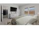 Bright bedroom with large window, TV, and convenient walk-in closet at 42510 W Peters Dr, Maricopa, AZ 85138